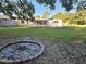 Large backyard with fire pit and spacious grassy area at 8030 Gulf Way, Hudson, FL 34667