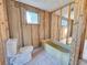 Unfinished bathroom with a toilet and bathtub at 8030 Gulf Way, Hudson, FL 34667