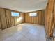 Unfinished bedroom with new tile floor and exposed walls at 8030 Gulf Way, Hudson, FL 34667