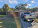 Brick ranch home with a two-car garage and driveway at 8030 Gulf Way, Hudson, FL 34667