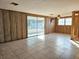 Large living room with tiled floors and sliding glass doors leading to a patio at 8030 Gulf Way, Hudson, FL 34667