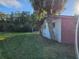 Brick home with a large side yard and palm trees at 8030 Gulf Way, Hudson, FL 34667