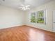 Bedroom with wood floors, large window, and access to a bath at 8689 Mississippi Run, Weeki Wachee, FL 34613