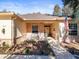 Front porch with brickwork, bench, and potted plants at 8689 Mississippi Run, Weeki Wachee, FL 34613