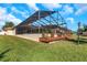 Backyard with deck and screened pool enclosure at 8700 Cessna Dr, New Port Richey, FL 34654