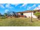 Backyard with a screened enclosure and lawn at 8700 Cessna Dr, New Port Richey, FL 34654