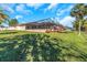 Landscaped backyard with screened pool enclosure at 8700 Cessna Dr, New Port Richey, FL 34654