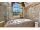 Relaxing bathroom with soaking tub and large window at 8700 Cessna Dr, New Port Richey, FL 34654