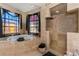 Luxurious bathroom with soaking tub, walk-in shower, and large windows at 8700 Cessna Dr, New Port Richey, FL 34654