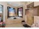Luxurious bathroom with soaking tub, walk-in shower, and large windows at 8700 Cessna Dr, New Port Richey, FL 34654