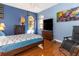 Bright bedroom with wood floors and large TV at 8700 Cessna Dr, New Port Richey, FL 34654