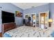 Bedroom with mirrored closet and access to exterior at 8700 Cessna Dr, New Port Richey, FL 34654