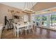 Bright dining room with white table and chairs, overlooking the pool at 8700 Cessna Dr, New Port Richey, FL 34654