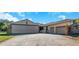 View of the large plane hangar and attached garage at 8700 Cessna Dr, New Port Richey, FL 34654