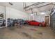 Three-car garage with storage shelving and a car at 8700 Cessna Dr, New Port Richey, FL 34654