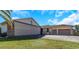 House exterior with attached hangar and three car garage at 8700 Cessna Dr, New Port Richey, FL 34654