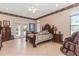 Main bedroom with king-size bed and access to a private patio at 8700 Cessna Dr, New Port Richey, FL 34654