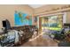 Bright home office with world map and sliding glass doors to patio at 8700 Cessna Dr, New Port Richey, FL 34654