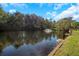 Serene pond view with lush landscaping and dock at 8700 Cessna Dr, New Port Richey, FL 34654