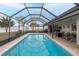 Relaxing screened pool with patio furniture at 8708 Woodlawn Ct, Port Richey, FL 34668