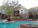 Community pool with brick decking and lounge chairs at 8718 Mallard Reserve Dr # 202, Tampa, FL 33614