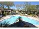Community pool and spa with surrounding landscaping at 8718 Mallard Reserve Dr # 202, Tampa, FL 33614
