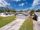 House with a large yard and a two-car garage at 9139 Fairweather Dr, Largo, FL 33773