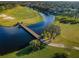 Aerial view of golf course and bridge over water at 11120 Wedgemere Dr, Trinity, FL 34655