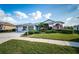 House exterior showcasing a two-car garage and lush lawn at 11120 Wedgemere Dr, Trinity, FL 34655