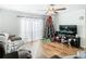 Living room featuring hardwood floors, a large TV and comfortable seating at 11380 Old Squaw Ave, Weeki Wachee, FL 34614