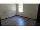 Simple bedroom with wood-look floors and a window at 12719 Lockey Ln, Tampa, FL 33612