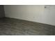 Simple bedroom with wood-look floors and a window at 12719 Lockey Ln, Tampa, FL 33612