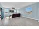 Light and airy living room with large windows and a brown leather sofa at 14004 Lugano Ct, Hudson, FL 34669