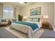 Main bedroom with king-size bed, two nightstands, and sitting area at 1705 Audubon Trl, Lutz, FL 33549