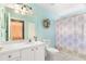 Clean bathroom with white vanity and floral shower curtain at 18109 Webster Grove Dr, Hudson, FL 34667