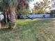 Large backyard with playset and tropical landscaping at 1922 Oswego Dr, Holiday, FL 34691