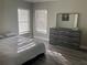 Spacious bedroom with large bed, dresser, and mirror at 1922 Oswego Dr, Holiday, FL 34691