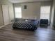 Well-lit bedroom with modern flooring and large window at 1922 Oswego Dr, Holiday, FL 34691