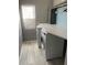 Bright laundry room with washer, dryer, and ample counter space at 1922 Oswego Dr, Holiday, FL 34691
