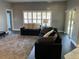 Relaxing living room featuring plush sofas and large windows at 1922 Oswego Dr, Holiday, FL 34691