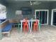 Covered patio with seating, a large TV, and built-in bench at 1922 Oswego Dr, Holiday, FL 34691