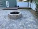 Brick patio with firepit and surrounding landscaping at 1922 Oswego Dr, Holiday, FL 34691