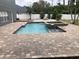Inviting pool and spa with a large brick patio at 1922 Oswego Dr, Holiday, FL 34691