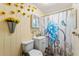 Bathroom with floral shower curtain and wood walls at 24141 Mondon Hill Rd, Brooksville, FL 34601