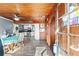 Bright dining area with wood-paneled walls and kitchen view at 24141 Mondon Hill Rd, Brooksville, FL 34601