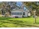 Single story home with a deck and lush green lawn at 24141 Mondon Hill Rd, Brooksville, FL 34601