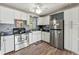 Galley kitchen with stainless steel appliances and white cabinets at 24141 Mondon Hill Rd, Brooksville, FL 34601