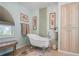 Relaxing bathroom with a clawfoot tub, decorative artwork, and built-in shelving at 247 Oriana Dr, Spring Hill, FL 34609