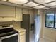 Stainless steel appliances and light beige cabinetry in kitchen at 2765 Countryside Blvd # 105, Clearwater, FL 33761