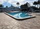 Community swimming pool with lounge chairs and patio area at 2765 Countryside Blvd # 105, Clearwater, FL 33761